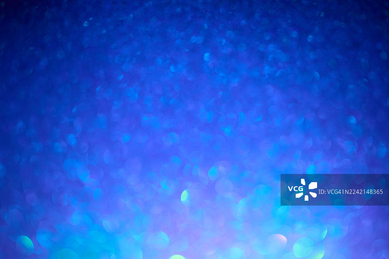 蓝色闪光散景背景，带有闪烁的光粒子，适用于抽象设计和节日项目图片素材