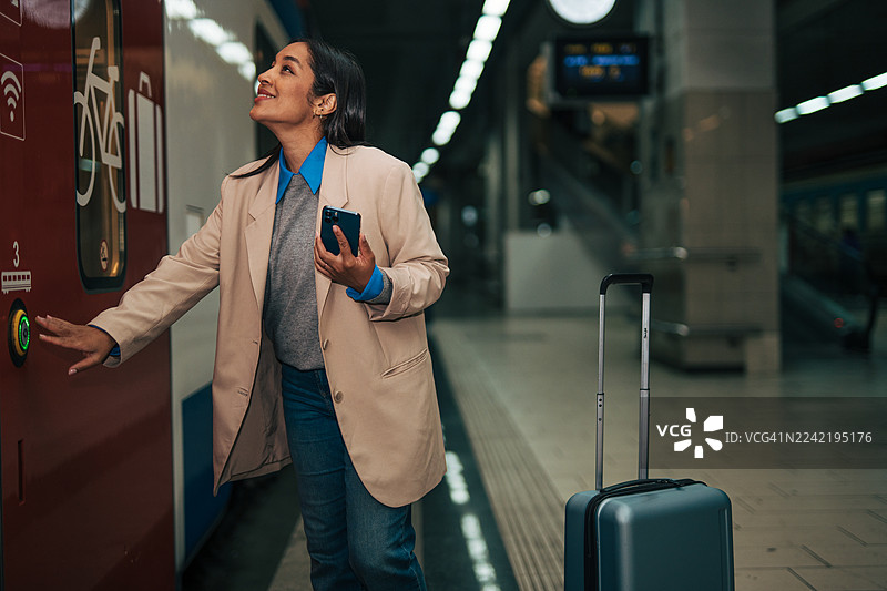 女子在地铁上按开门按钮图片素材