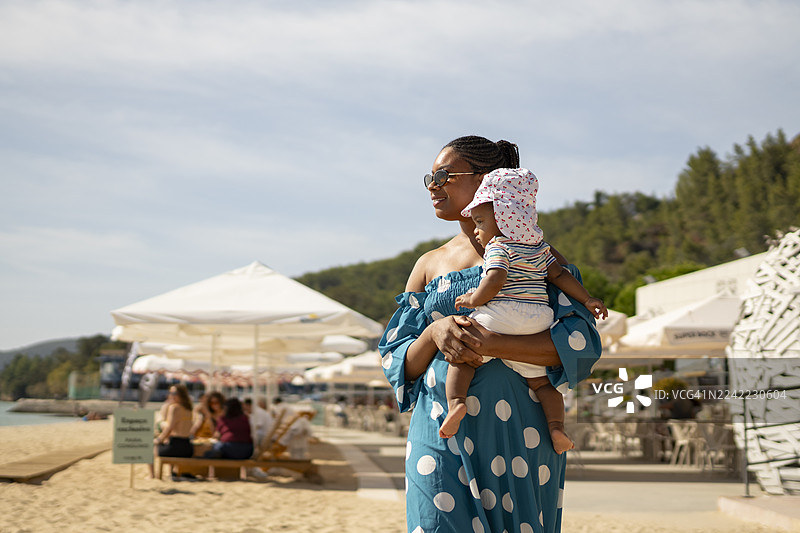 非裔母亲和新生女儿在塞图巴尔海滩酒吧图片素材