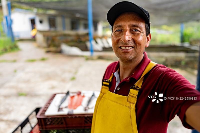 农民在鳟鱼养殖场进行视频通话 - 摄像头视角图片素材