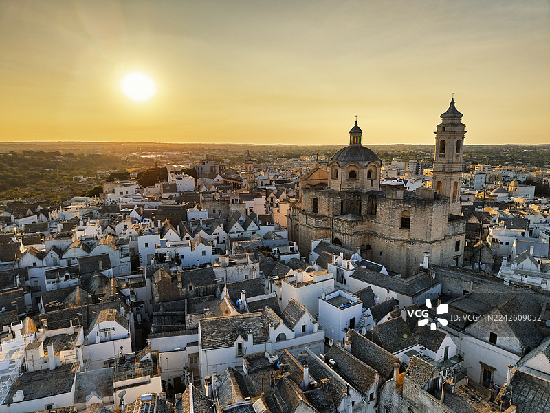 俯瞰日落时分的洛科罗通多，那里有圆顶和白墙建筑，位于意大利普利亚。图片素材