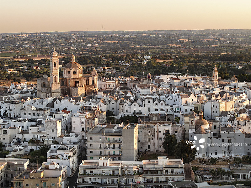 意大利普利亚，洛托隆多日落时分的鸟瞰图，有圆顶和粉刷成白色的建筑图片素材