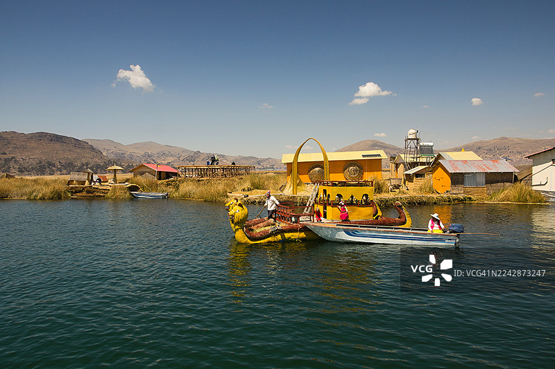 的的喀喀湖畔的托托拉芦苇独木舟与机动船，乌鲁斯浮岛村庄图片素材