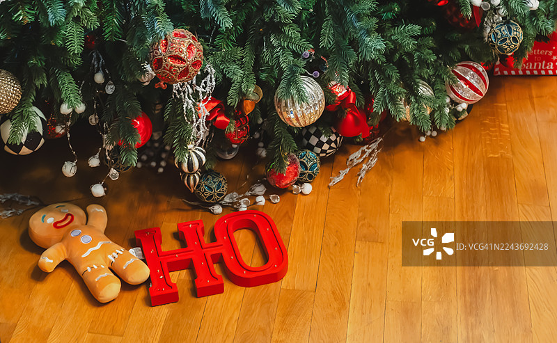 节日混乱：倒下的圣诞树，装饰品破碎，节日装饰品摆放在舒适的客厅里图片素材