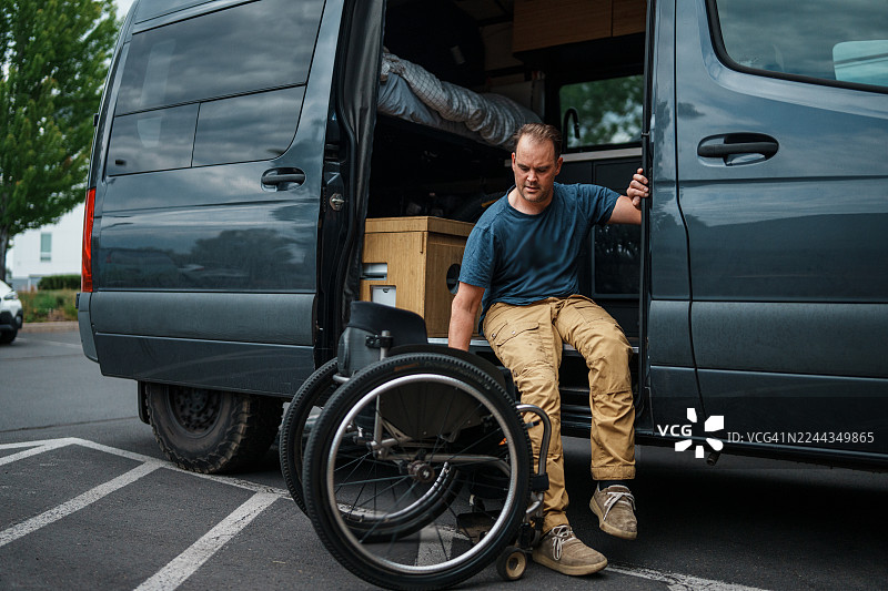 一名使用轮椅的男子正从货车中出来图片素材