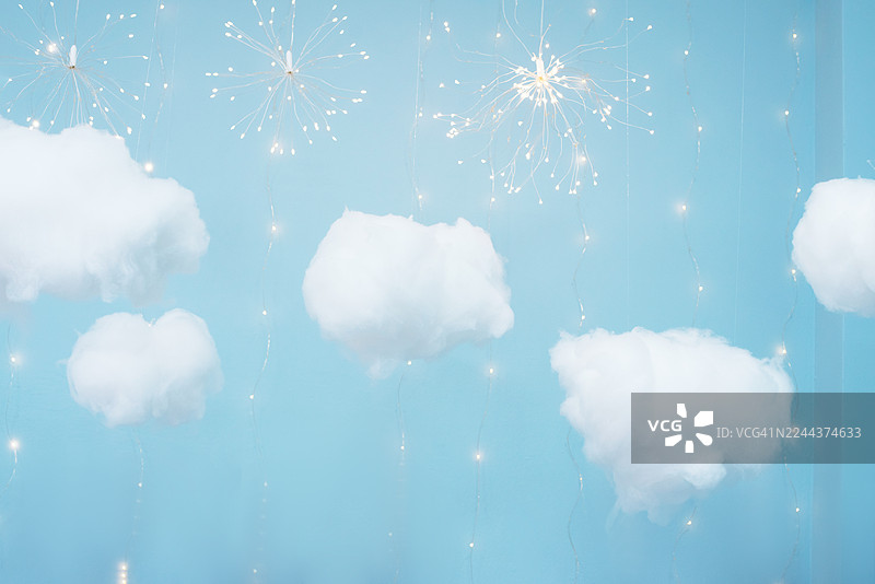 人造云和模拟天空。蓝色的背景，有轻盈的云彩。月亮和云彩。烟花。星星。图片素材