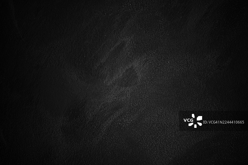 一张带有暗角效果的深色水泥墙图片素材