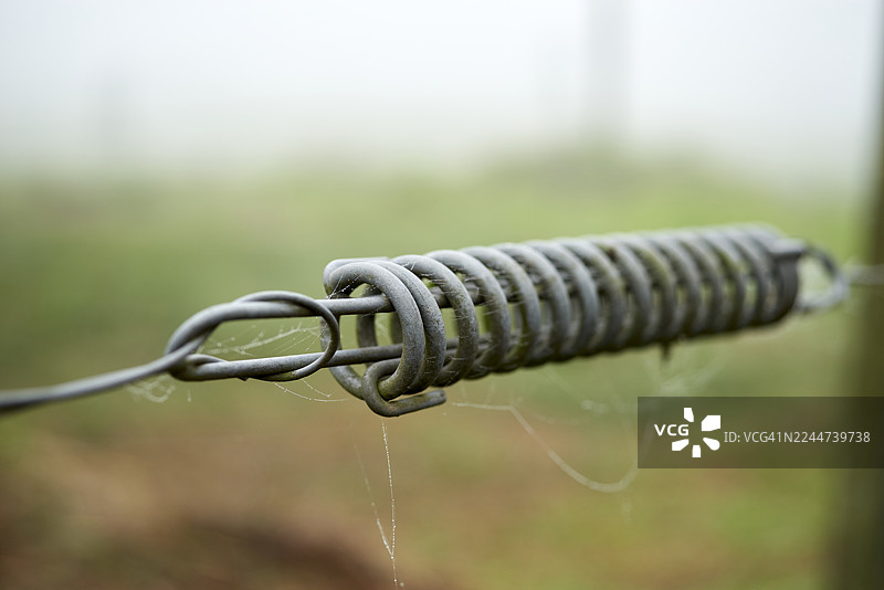 金属弹簧和铁丝网在雾中的特写图片素材