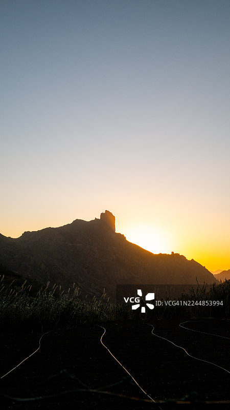 日出时大加那利岛的罗克本塔伊加山剪影图片素材