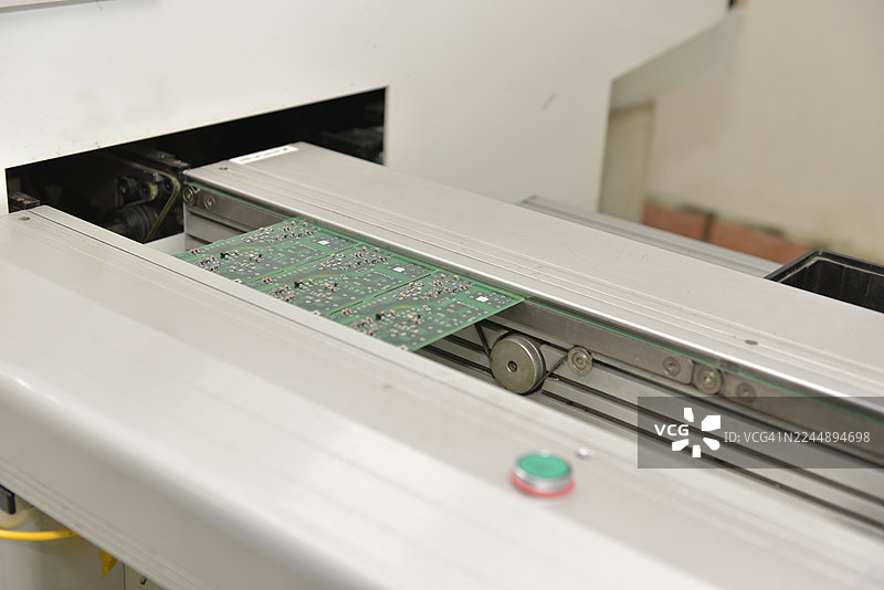 电子制造工厂的表面贴装组装线上带有SMT元器件的PCB板图片素材