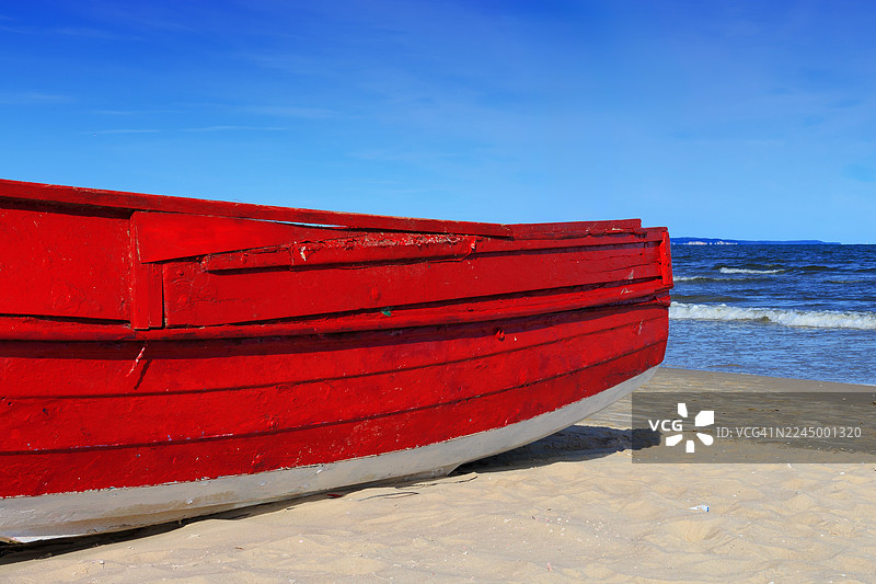 红色的游艇停靠在海滩上图片素材