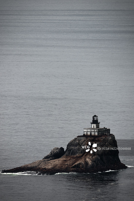 位于美国太平洋上的标志性历史灯塔——蒂拉穆克岩灯塔，坐落于孤立的礁石上，天空戏剧般地变幻着。图片素材
