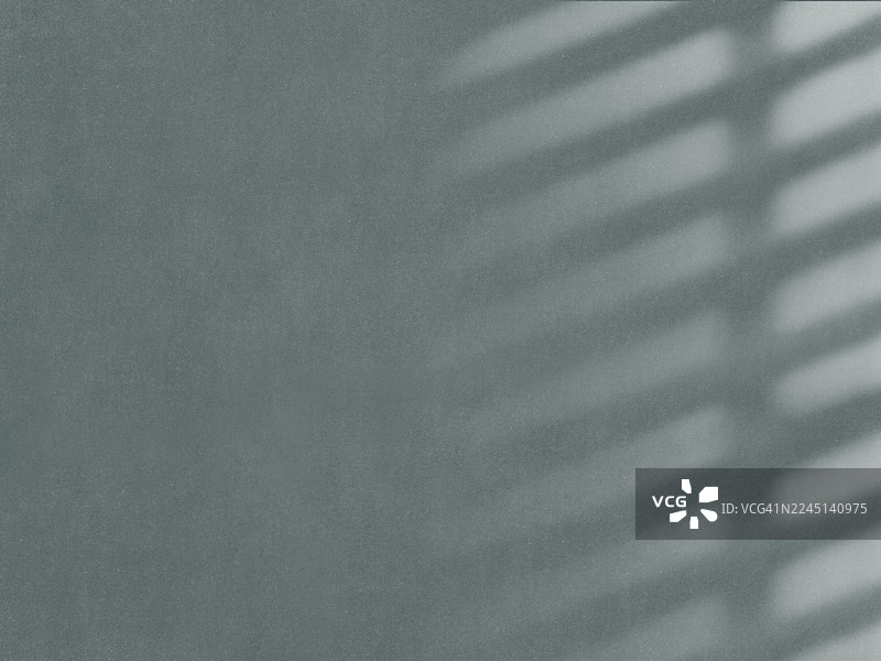 光滑柔软的绿色墙壁上的阴影。图片素材