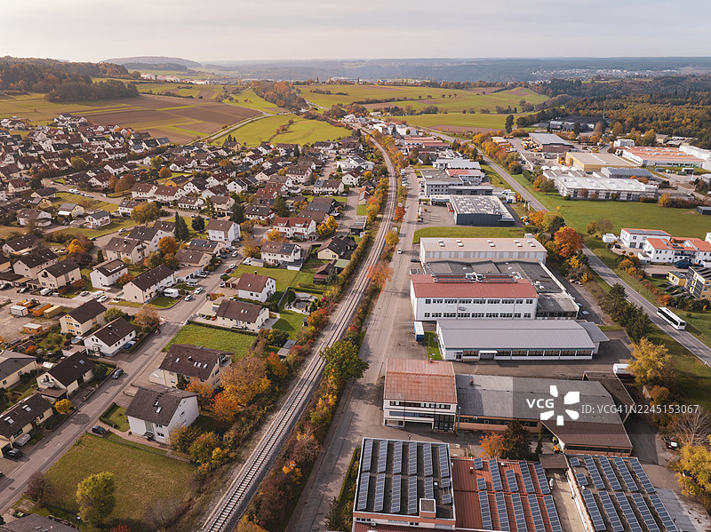 秋季的城市景观，赫尔曼·黑塞铁路（Hermann Hesse Bahn）线路穿过房屋和工业建筑之间，位于德国卡尔夫区阿尔滕施泰特。图片素材