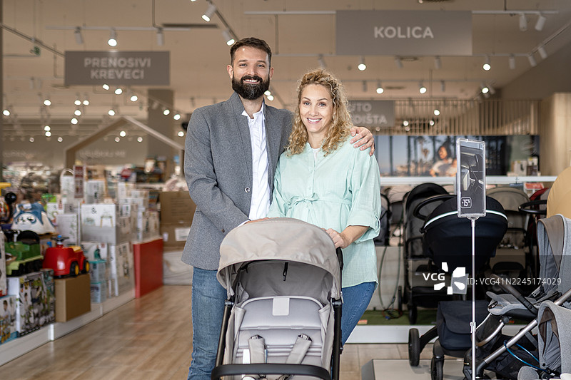 期待的父母在母婴店选购婴儿车图片素材