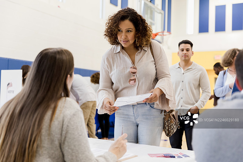 多元化的人们在社区投票站投票互动投票。图片素材