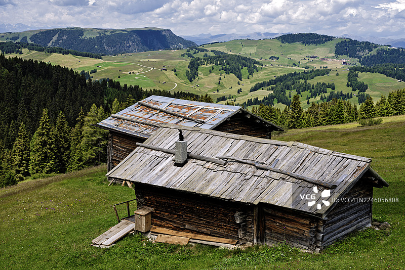 塞泽尔阿尔姆多洛米蒂山区点缀着传统的木屋图片素材