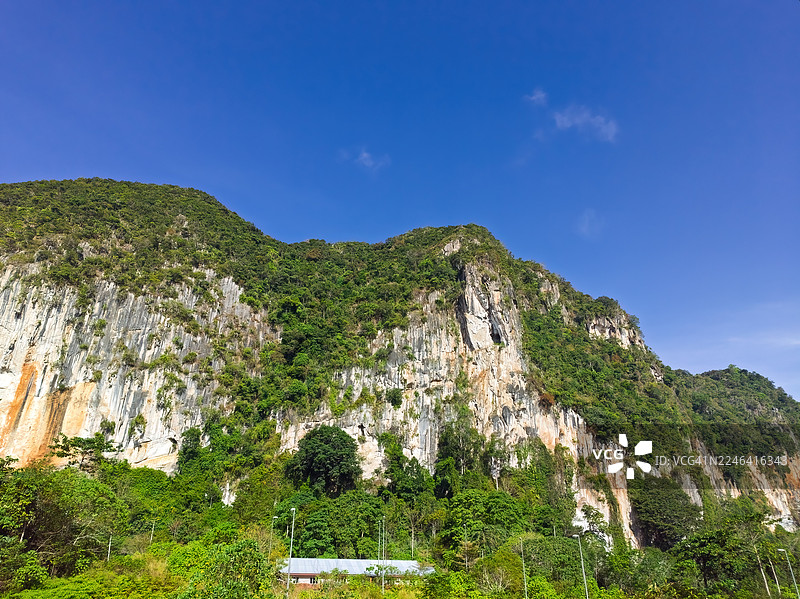 郁郁葱葱的青山和湛蓝的天空构成了一幅令人惊叹的自然景观，展现了热带地区原始的美丽图片素材