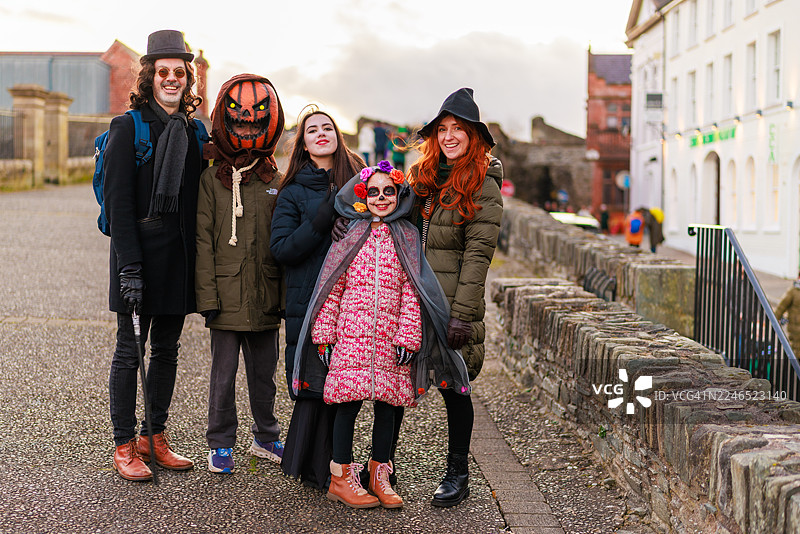 万圣节，一家人穿着戏服走在德里历史悠久的城墙上图片素材