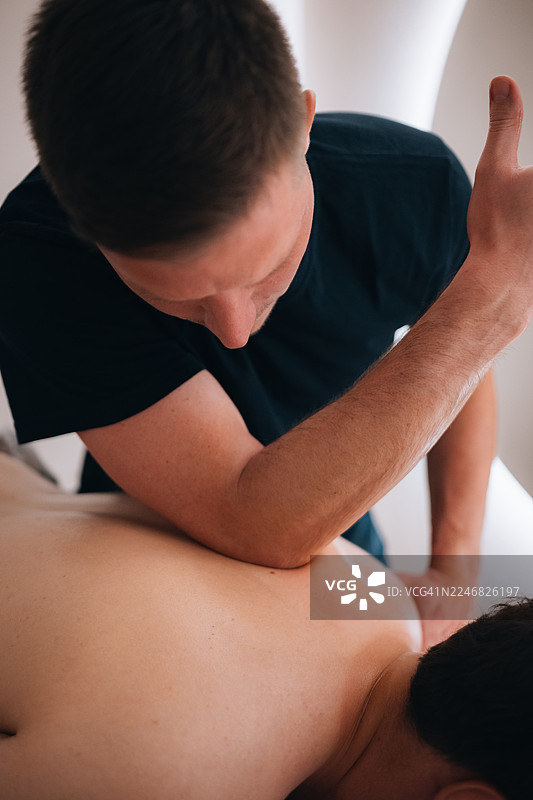 理疗师为男病人提供治疗性按摩图片素材