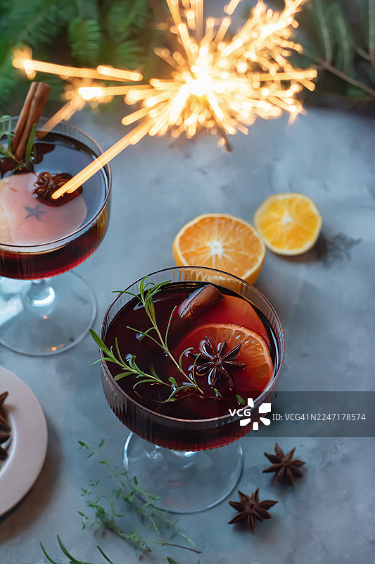 玻璃杯中的热红酒、水果和香料潘趣酒。一种传统的冬季饮品。圣诞和新年的氛围。图片素材