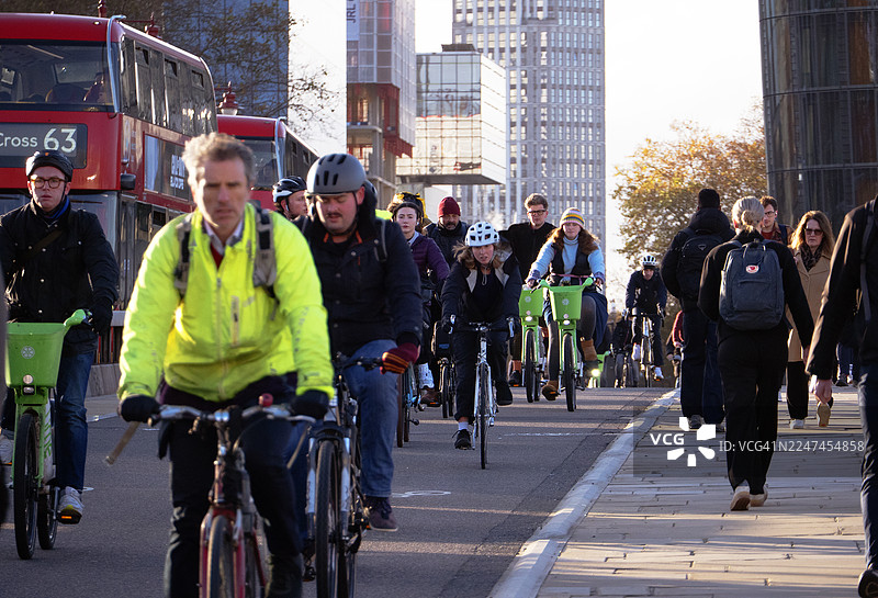 阳光明媚的秋日清晨，上班族骑行和步行通勤图片素材