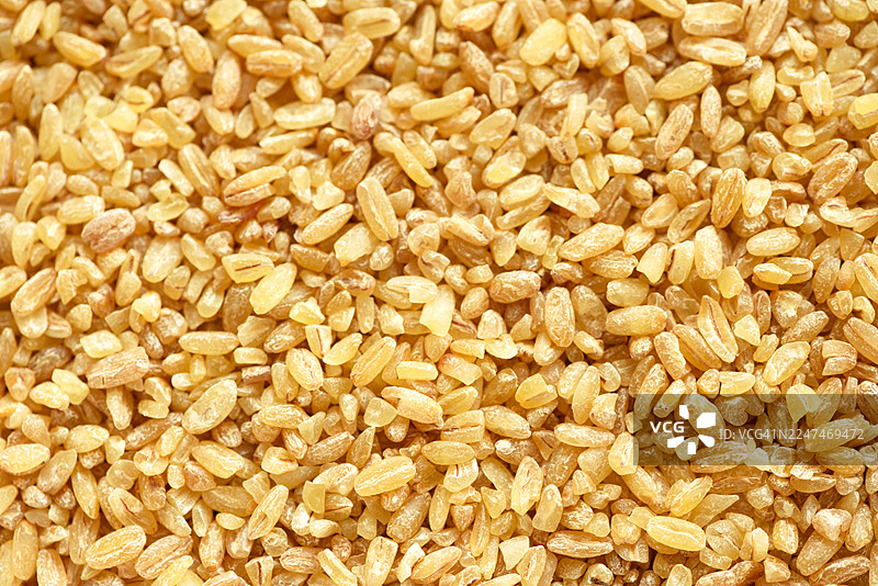 金黄稻米特写纹理：用于食品、食品储藏室、烹饪和市场品牌推广的生未煮米粒图片素材