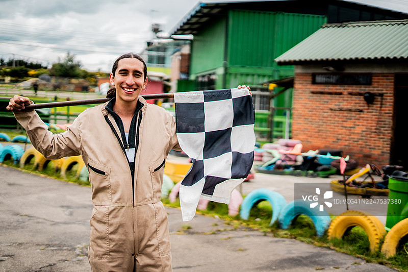 赛车官员在卡丁车赛道挥舞方格旗的肖像图片素材