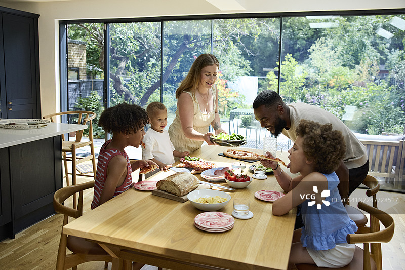 多元种族家庭成员在家吃午餐图片素材