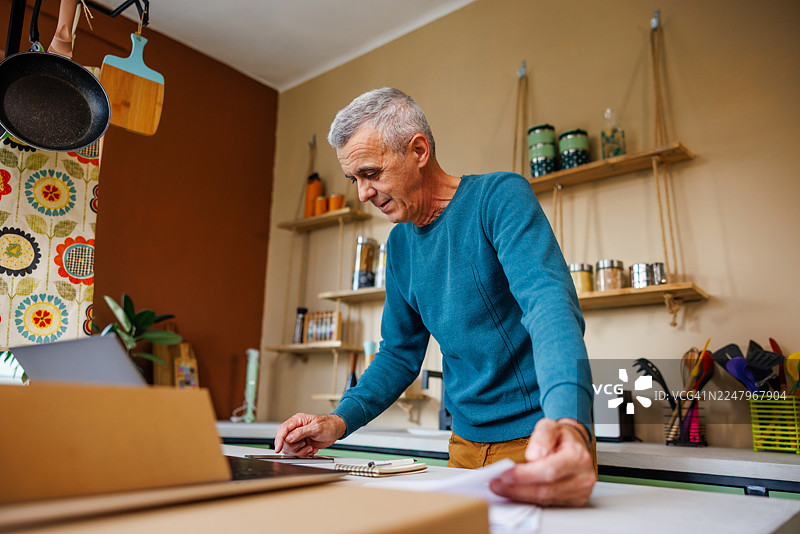 年长男性正在查看财务记录图片素材