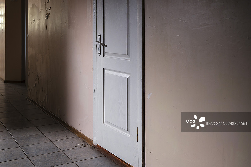 被遗弃的门廊，露出一条黑暗破败的走廊图片素材