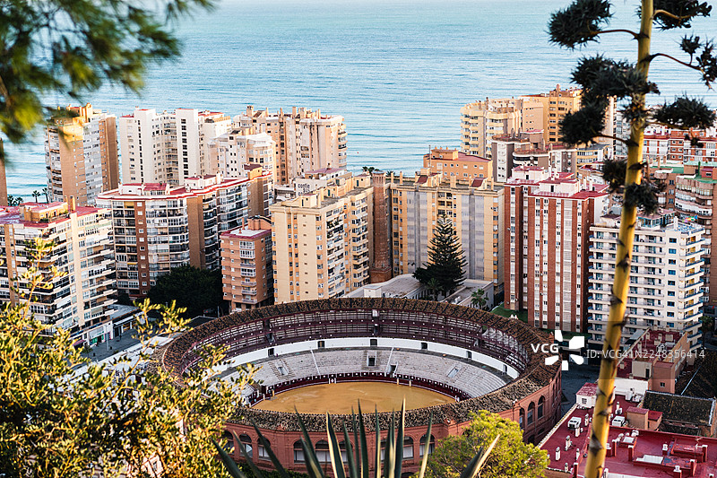 西班牙马拉加圆形斗牛场鸟瞰图，周边环绕着高层建筑和大海图片素材