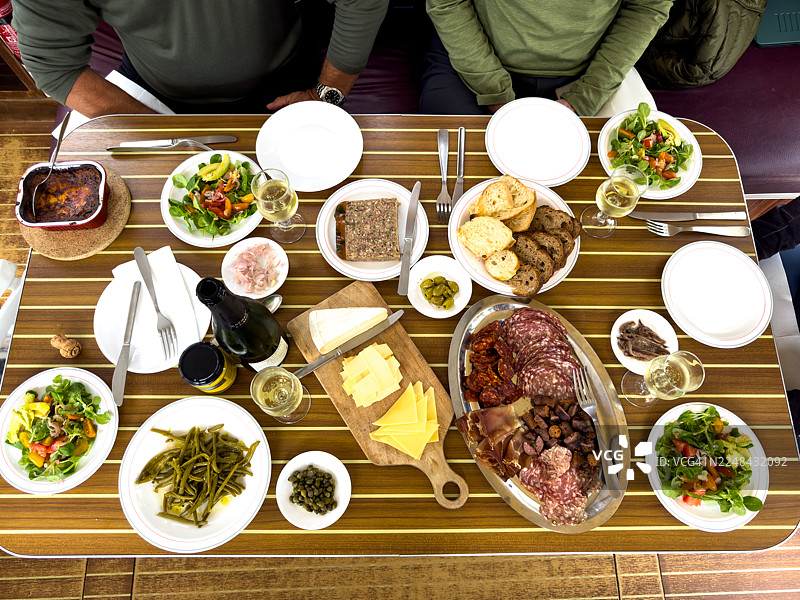 桌上摆放着各式各样的熟食和沙拉。图片素材
