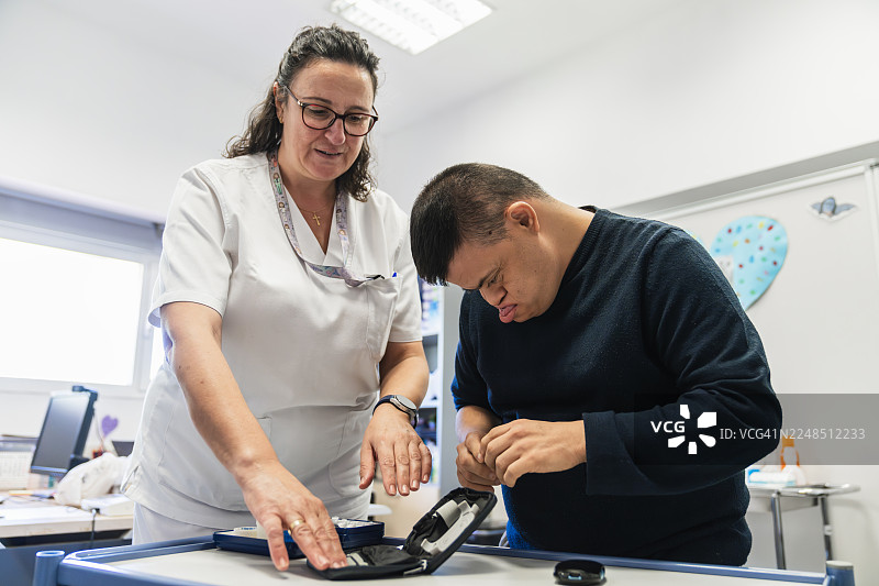 患有唐氏综合征的护士和患者正在准备胰岛素药物图片素材
