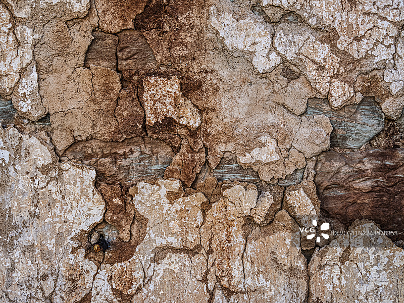古老的石头外墙，有裂缝和孔洞的损坏。图片素材