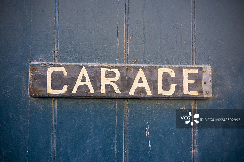 老式汽车修理厂招牌挂在木门上图片素材