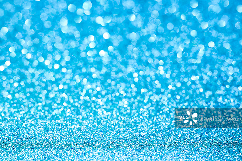 蓝色背景，带有闪亮的闪光和散景图片素材