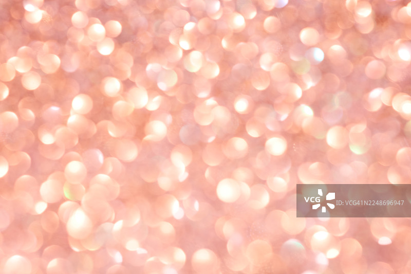 明亮的橙色抽象背景，带有闪亮的散景图片素材