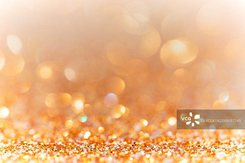 闪光。明亮的橙色抽象背景，带有闪耀的散景图片素材