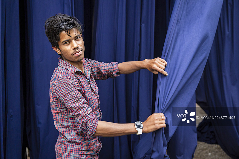 印度斋浦尔，男子正在处理靛蓝染料织物图片素材