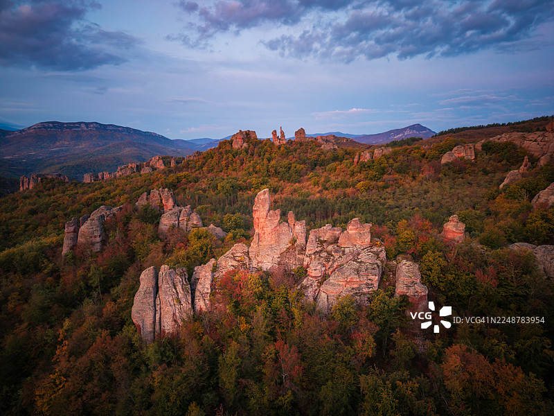 保加利亚贝洛格拉奇克地区，阴天下的戏剧性岩层与鲜艳的秋季树木图片素材