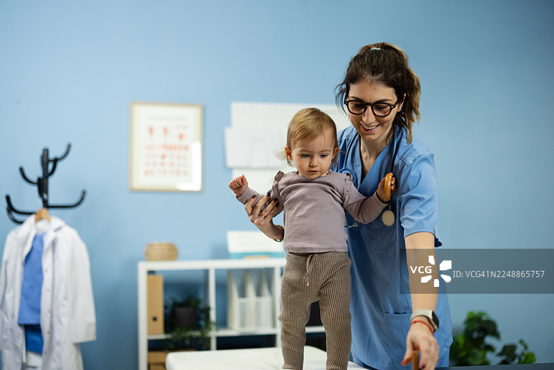 医生在体检中检查婴儿发育情况图片素材