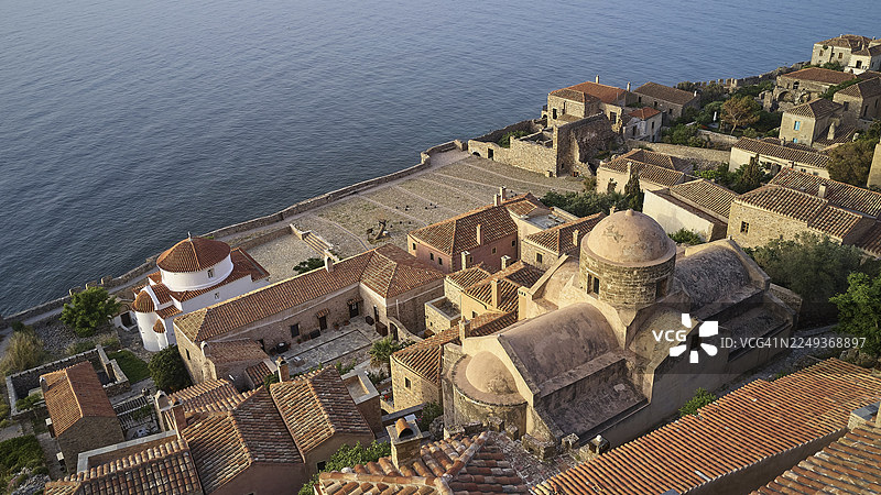 无人机视角,圣母玛利亚·克里萨菲提萨教堂,海边的历史小镇,铺着瓦片的屋顶和教堂,莫奈姆瓦夏,莫奈姆瓦夏,马尔瓦西亚,拜占庭小镇,岩石岛,城堡,拉科尼亚,伯罗奔尼撒,半岛,希腊图片素材