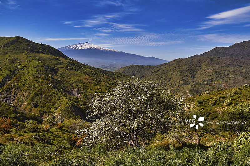 春天时的埃特纳火山，背景是风景如画的火山，山上鲜花盛开，天空明亮，埃特纳火山是联合国教科文组织世界遗产，火山，火山活动，西西里岛，意大利图片素材