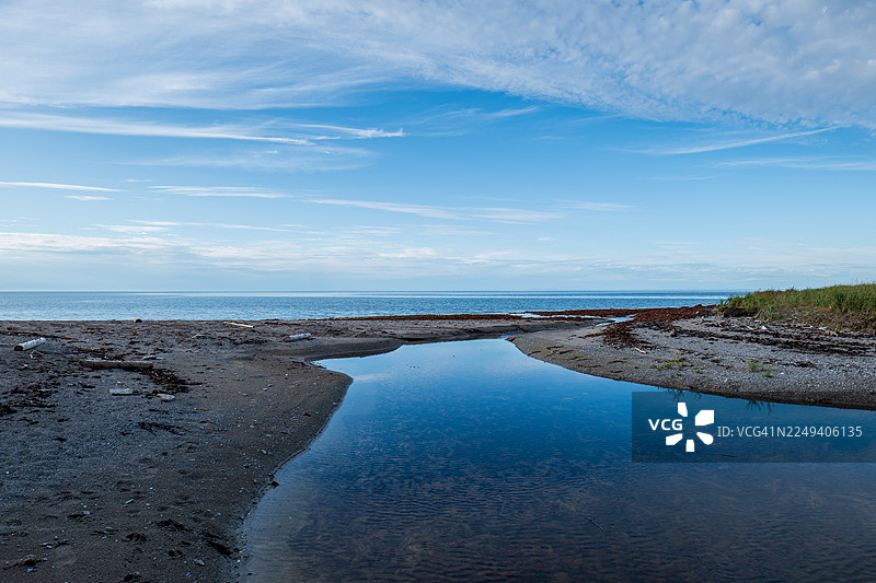 夕阳下的圣劳伦斯河，在魁北克省安蒂科斯蒂岛的大马卡斯蒂，平静的湖水汇入溪流，最终流向圣劳伦斯河。图片素材