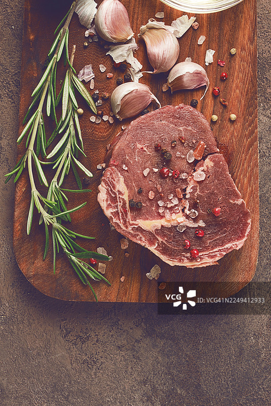 新鲜的生牛眼肉排，放在砧板上，俯视视角，无人物图片素材