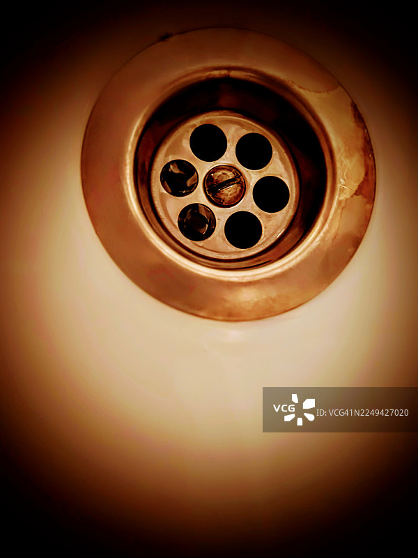 浴室水槽排水口的俯视视角，显示出锈迹和污垢图片素材