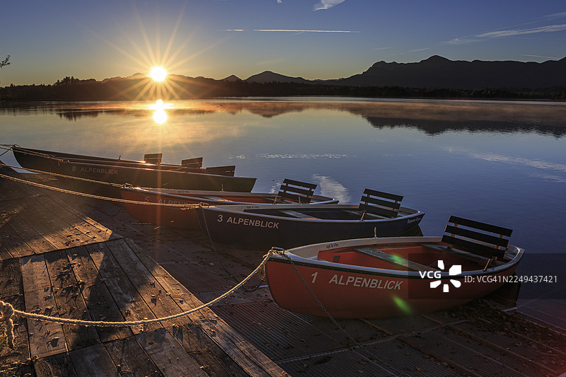 划艇，日出，湖泊，山峦倒映在水中，斯塔费尔湖，穆尔瑙，阿尔卑斯山麓，巴伐利亚，德国图片素材