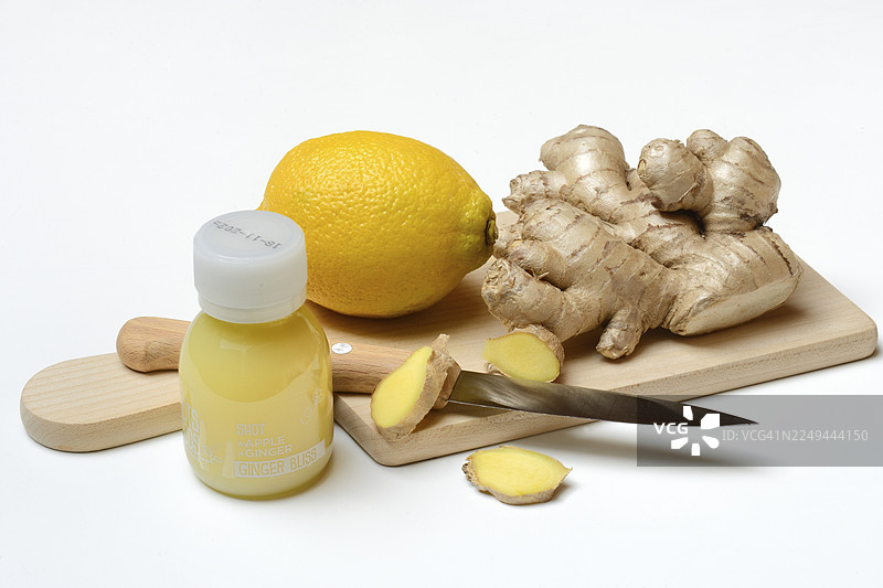 砧板上的姜根和柠檬，以及一杯姜汁饮品图片素材