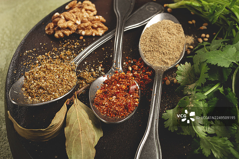 乔治亚香料放在勺子里，在克齐（一种陶制平底锅）上，俯视视角，无人图片素材